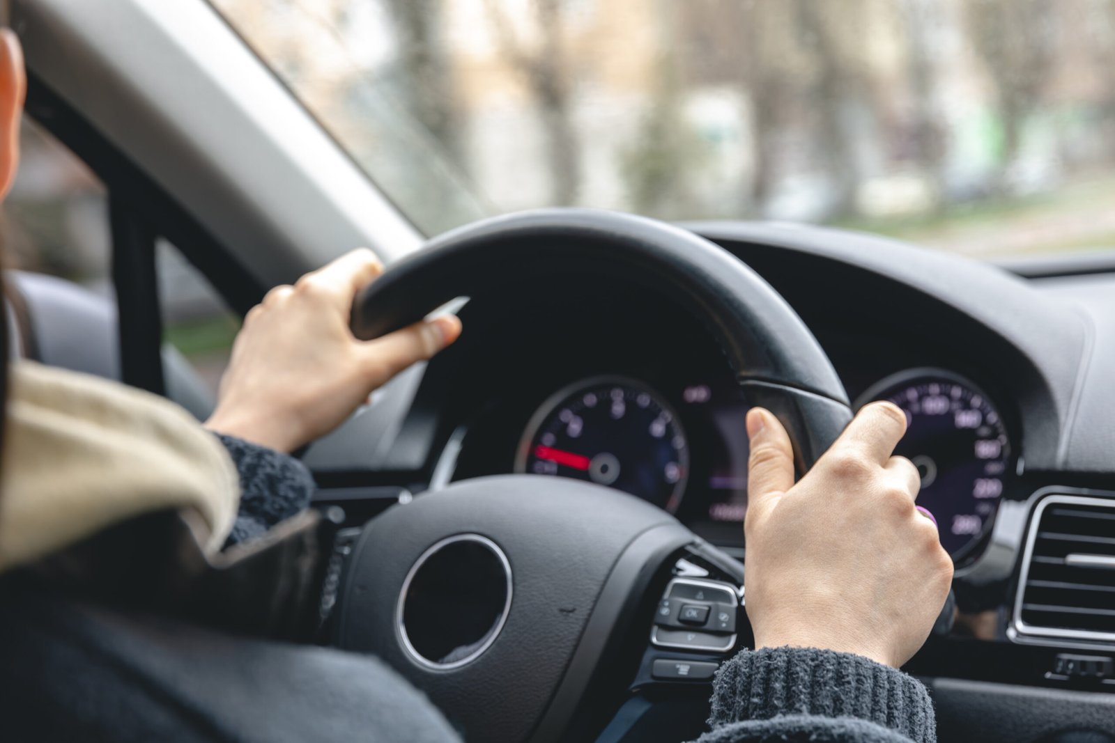 woman drivers hands car steering wheel scaled